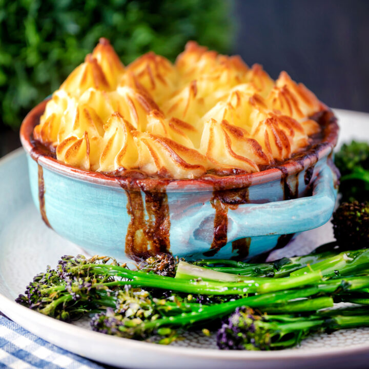 Individual sausage and mash pie served with roasted tenderstem broccoli.
