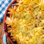 Close up overhead sausage and mash pie.