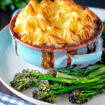 Sausage and mash pie served with roasted tenderstem broccoli.