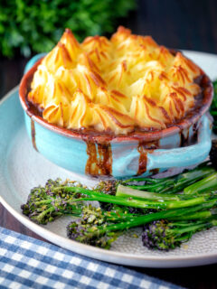 Sausage and mash pie served with roasted tenderstem broccoli.