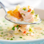 Close up of a spoonful of slow cooker salmon chowder.