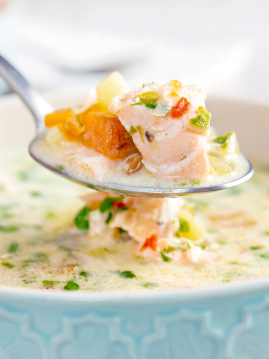 Close up of a spoonful of slow cooker salmon chowder.