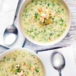 Overhead of two bowls of slow cooker salmon chowder.