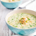 Slow cooker salmon chowder served in blue bowls.