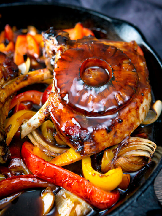 Skillet sweet and sour pork chops with pineapple rings and peppers.