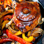 Skillet sweet and sour pork chops with pineapple rings and peppers featuring a title overlay.