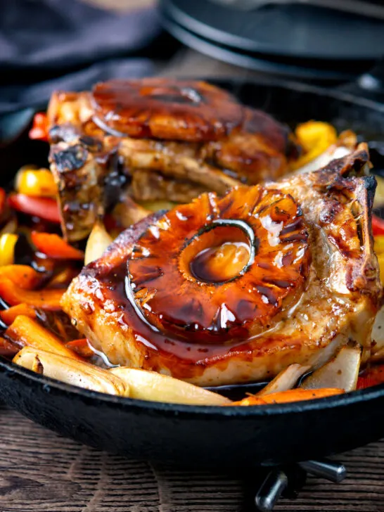 Sweet and sour pork chops with pineapple rings and peppers.