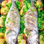 Baked or roasted sea bass with new potatoes, peas, broad beans and bacon featuring a title overlay.