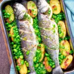 Overhead baked or roasted sea bass with new potatoes, peas, broad beans and bacon featuring a title overlay.