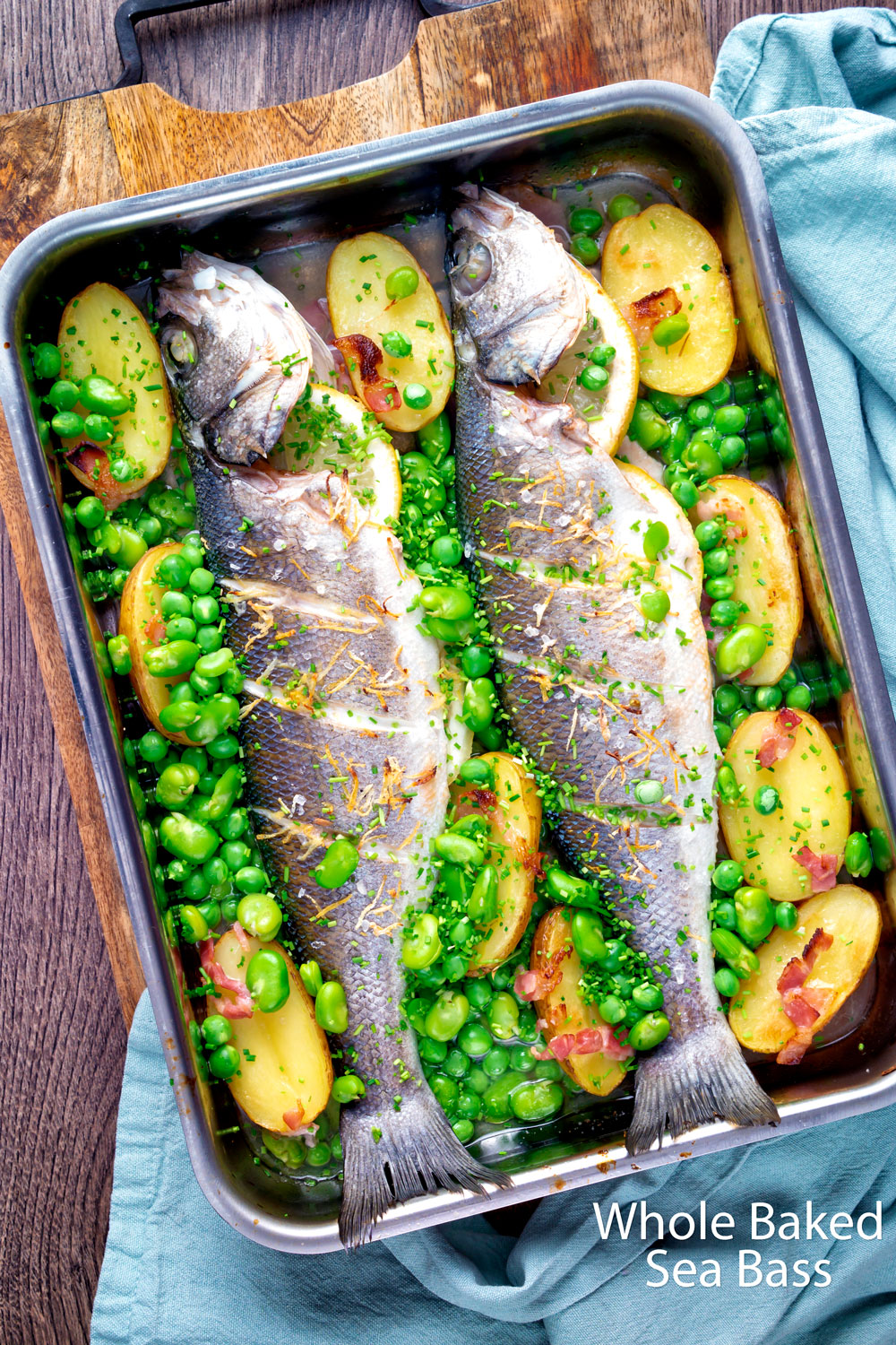 Whole Baked Sea Bass Recipe with Potatoes, Broad Beans and Peas. Krumpli