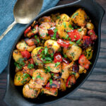 Overhead batata harra Lebanese or Syrian spicy potatoes with red peppers.