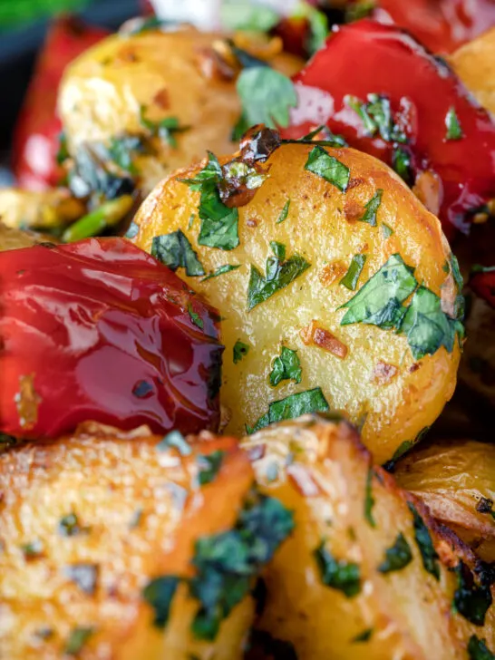 Close up batata harra Lebanese or Syrian spicy potatoes with red peppers.