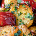 Close up batata harra Lebanese or Syrian spicy potatoes with red peppers featuring a title overlay.