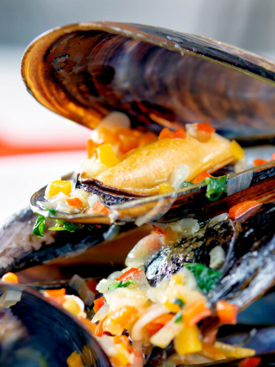 Close up beer steamed mussels with shallot, chilli and garlic.