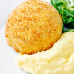 Golden chicken Kyiv served with mashed potato.