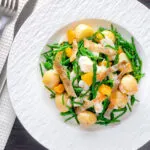 Overhead cod fish salad with asparagus, samphire, new potatoes and orange.