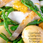 Close up cod fish salad with asparagus, samphire, new potatoes and orange featuring a title overlay.