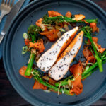 Overhead steamed Korean gochujang chicken breast with broccoli and kimchi.