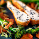 Close up steamed Korean gochujang chicken breast with broccoli and kimchi.