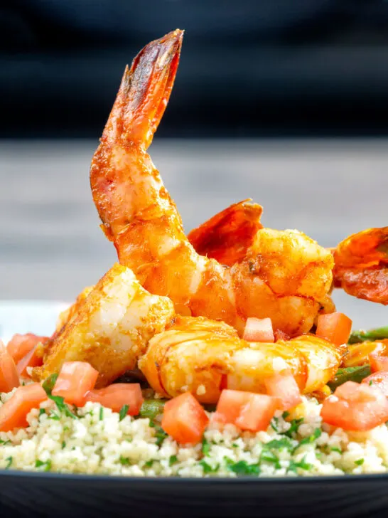 Moroccan influenced garlic harissa prawns served with couscous.