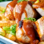 Close up homemade German currywurst with French fries.
