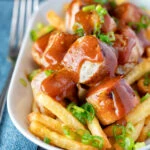Homemade German currywurst with French fries.