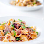 Instant Pot pork ragu with orecchiette pasta served in a white bowl.