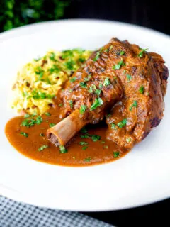 Lamb shank curry or nalli gosht served with pilau rice.