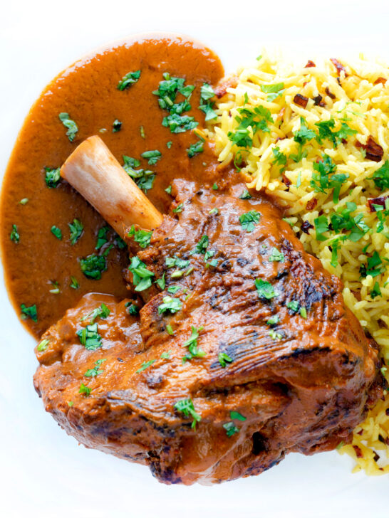 Overhead close up lamb shank curry or nalli gosht served with pilau rice.