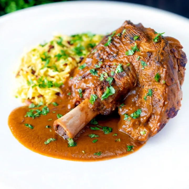 Slow Cooked lamb shank curry or nalli gosht served with pilau rice.