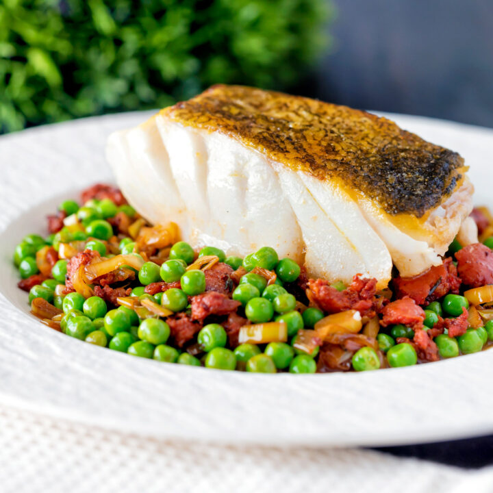 Easy pan fried cod loin with crispy skin, chorizo, peas and leeks.