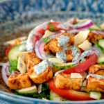 Paneer tikka salad with yoghurt raita dressing.