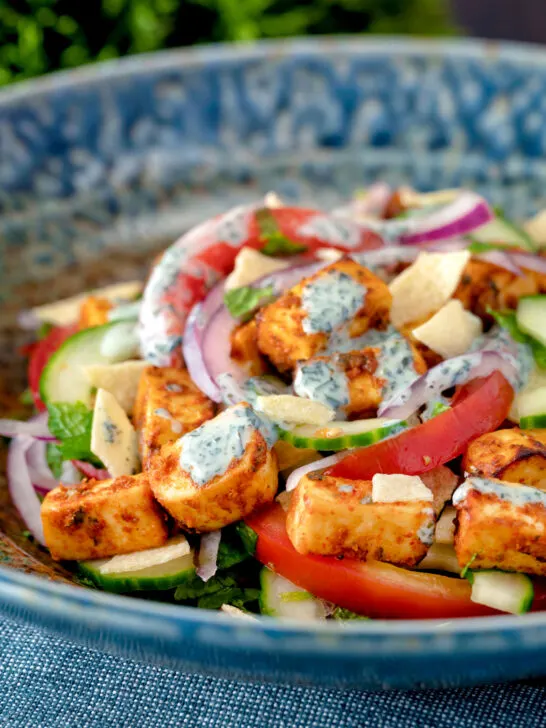 Paneer tikka salad with yoghurt raita dressing.