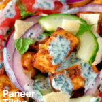 Close up paneer tikka salad with yoghurt raita dressing featuring a title overlay.