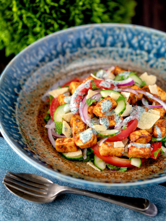 Paneer tikka salad with cucumber, tomato, onion and yoghurt raita dressing.