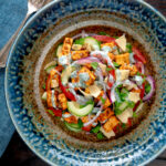 Overhead paneer tikka salad with yoghurt raita dressing.