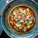 Overhead paneer tikka salad with yoghurt raita dressing.