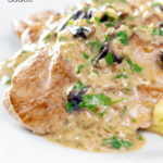 Close up pork tenderloin with prunes in a brandy cream sauce featuring a title overlay.