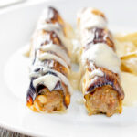 Skinless sausage meat stuffed leeks with pear and cider sauce.