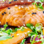 Close up crispy skinned sweet and sour salmon fillets.