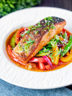 Crispy skinned sweet and sour salmon fillets with peppers and sugar snap peas.