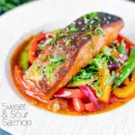 Crispy skinned sweet and sour salmon fillets with peppers and sugar snap peas featuring a title overlay.