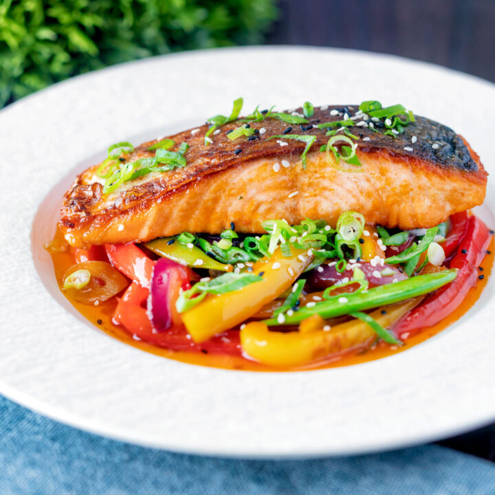 Pan fried sweet and sour salmon fillets with peppers and sugar snap peas.