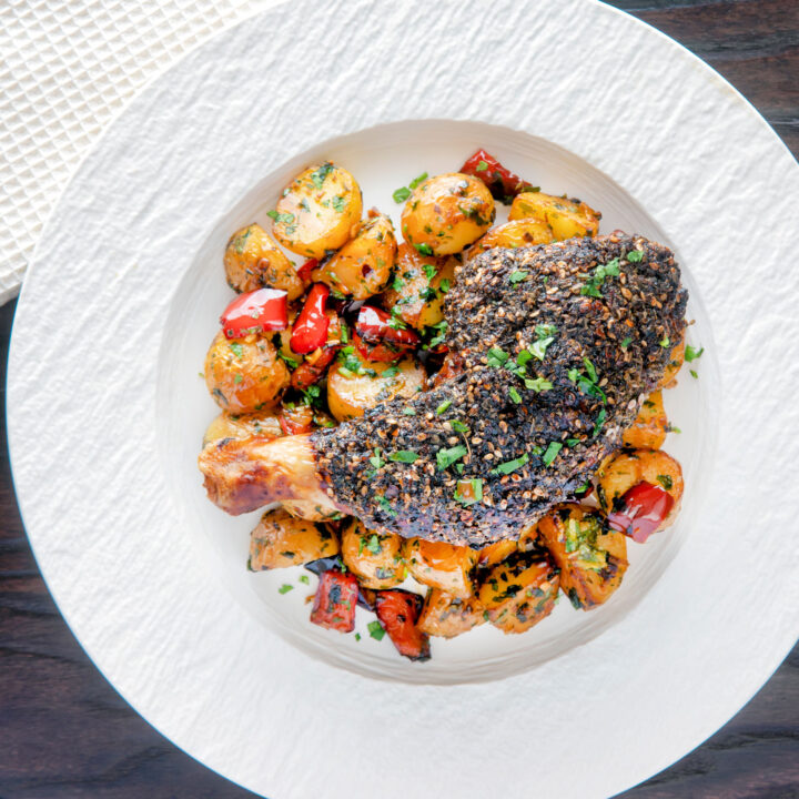 Roasted zaatar crusted chicken legs served with batata harra.