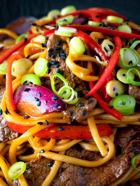 Close up Beef noodle stir fry with sweet chilli sauce and red peppers.