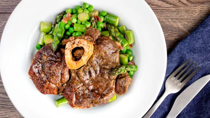 Slow cooked braised beef shin on the bone with peas, asparagus and bacon.