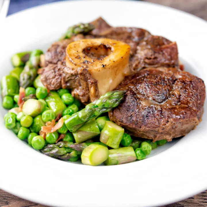 Slow cooked braised beef shin on the bone with peas, asparagus and bacon.