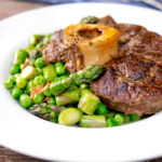 Braised beef shin with peas, asparagus and bacon.