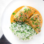 Overhead Thai mackerel choo chee curry served with coriander rice.