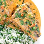 Close up overhead Thai choo chee curry served with coriander rice.